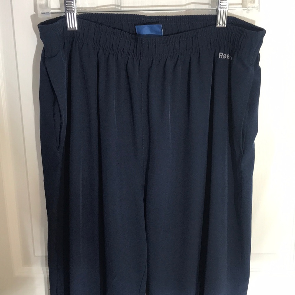 Navy reebok sweat pants with zipper bottoms